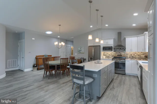 a large kitchen with a table and chairs