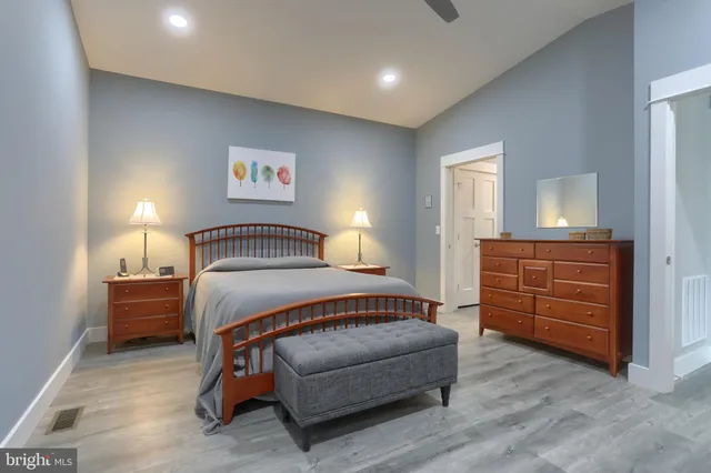 a bedroom with a bed and a lamp on table