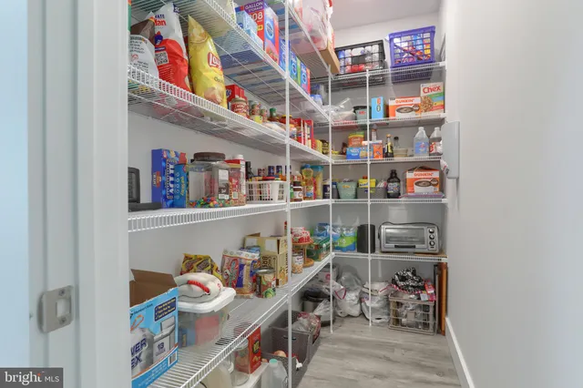a bathroom with a granite countertop sink a toilet and a mirror