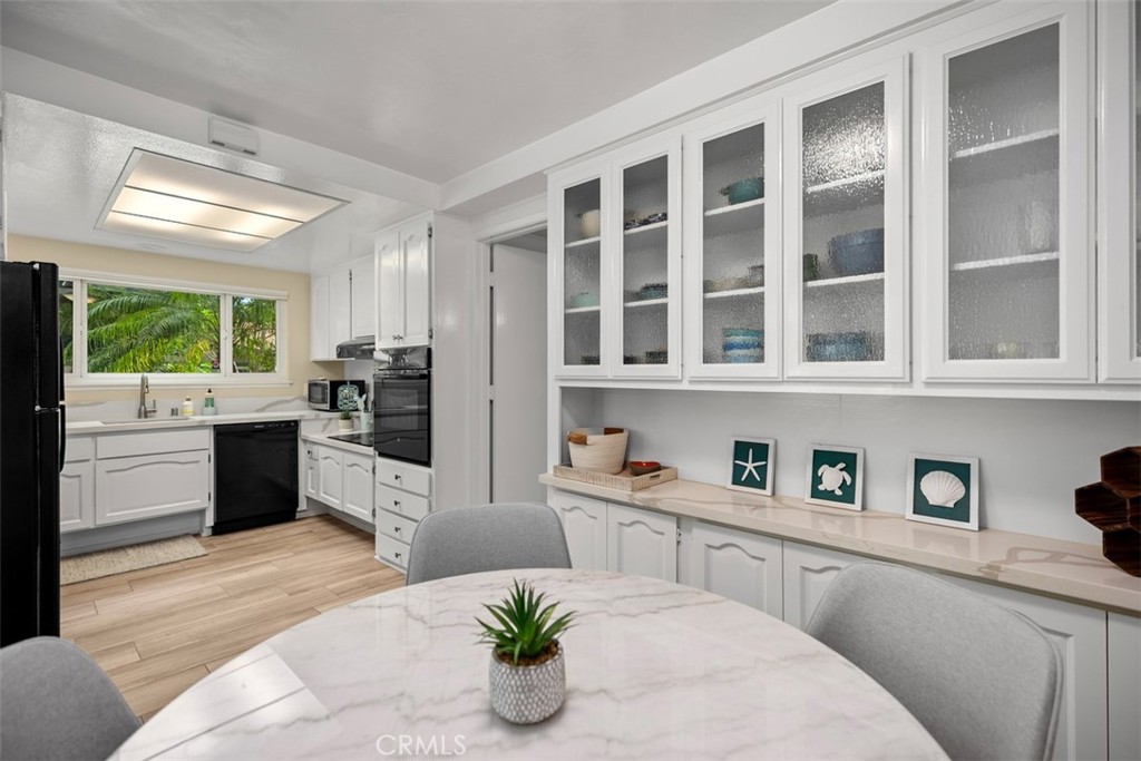 839 Ronda Sevilla, Unit A Laguna Woods, CA 92637 - Photo 13 of 34 a kitchen with a refrigerator and window