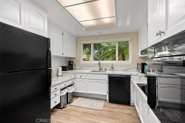 a kitchen with a sink stove and refrigerator