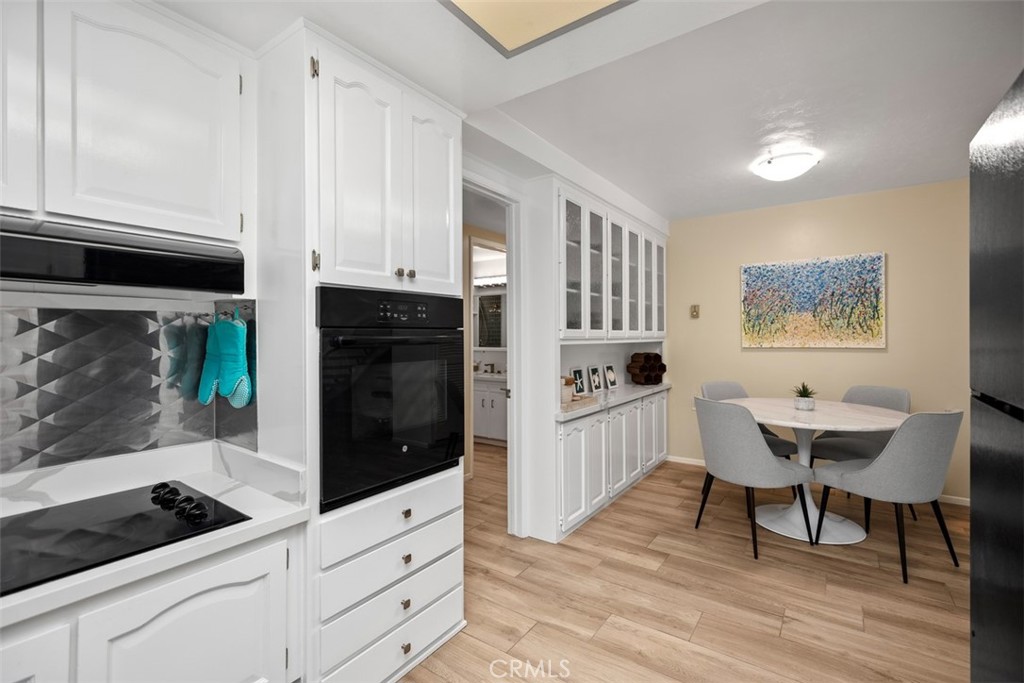 839 Ronda Sevilla, Unit A Laguna Woods, CA 92637 - Photo 18 of 34 a kitchen with stainless steel appliances kitchen island granite countertop a stove a sink and a microwave