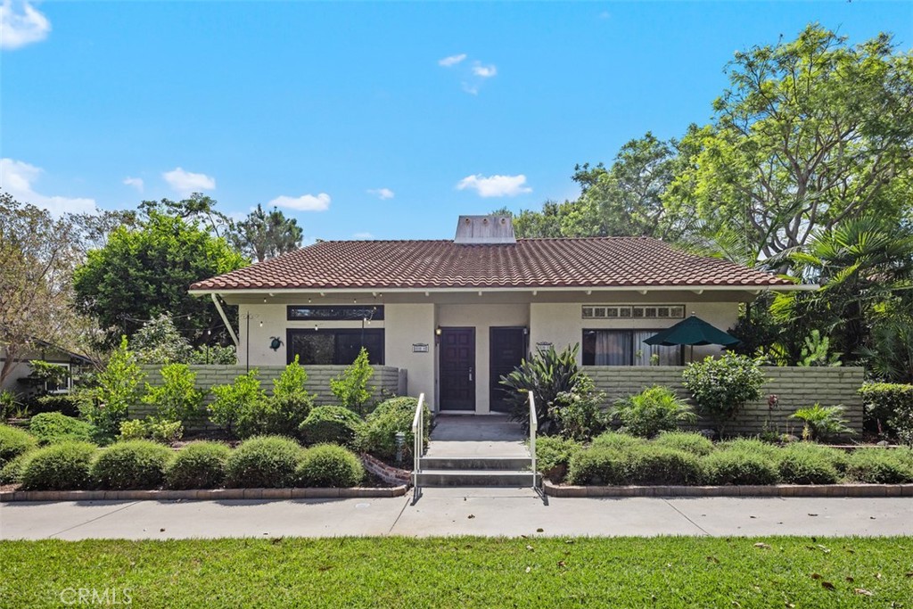 839 Ronda Sevilla, Unit A Laguna Woods, CA 92637 - Photo 2 of 34 a front view of a house with a yard