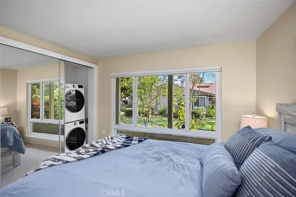 a living room with furniture a flat screen tv and a large window