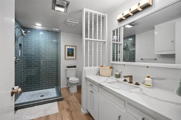 a bathroom with a double vanity sink toilet and shower