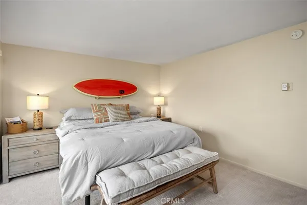 a bedroom with a bed and a lamp