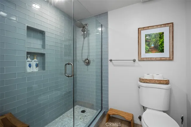 a white toilet sitting next to a bathroom sink
