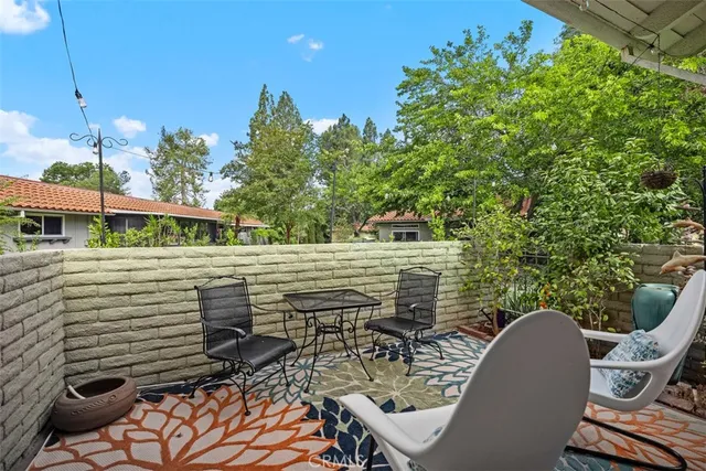 a view of a chairs and table in the balcony