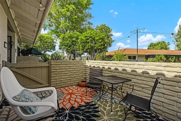 a view of a patio with table and chairs and potted plants