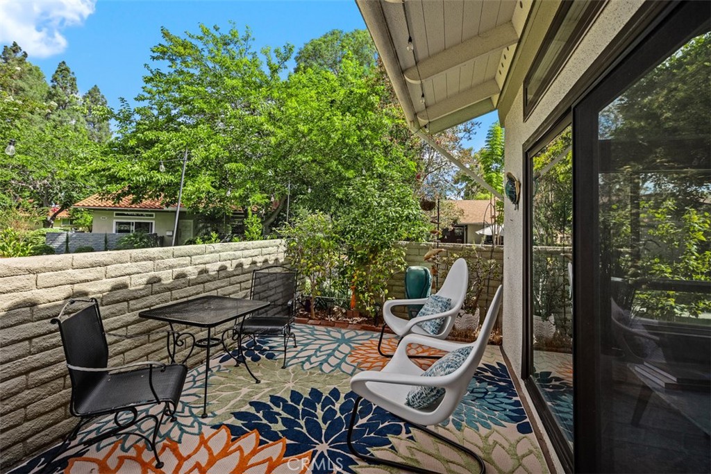 839 Ronda Sevilla, Unit A Laguna Woods, CA 92637 - Photo 34 of 34 a view of a chairs and table in patio with a yard