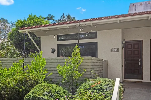 a view of a house with potted plants