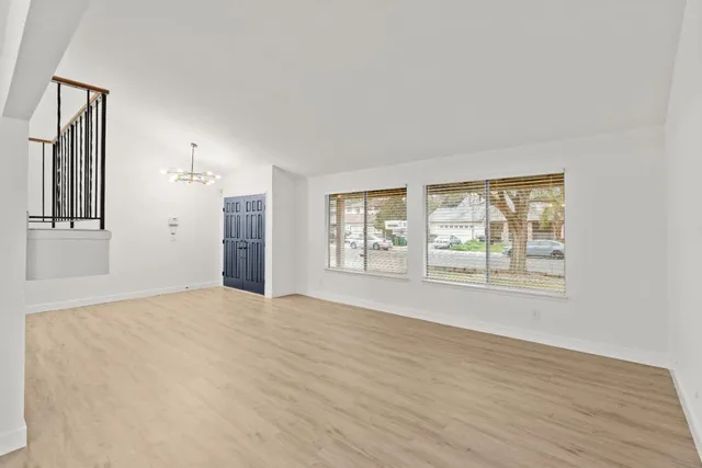 a view of kitchen with wooden floor and refrigerator