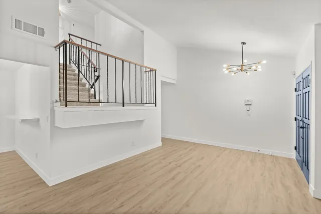 a view of a kitchen with wooden floor and electronic appliances