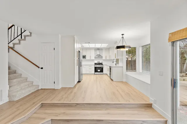a bathroom with a granite countertop sink a toilet and shower