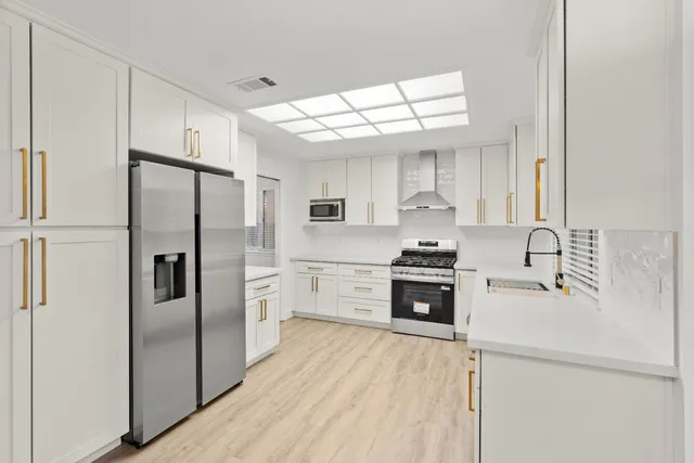 a view of a kitchen with wooden floor and a fireplace