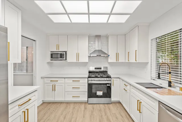 an empty room with fireplace and windows