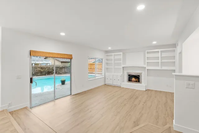 a view of a hallway with white cabinets