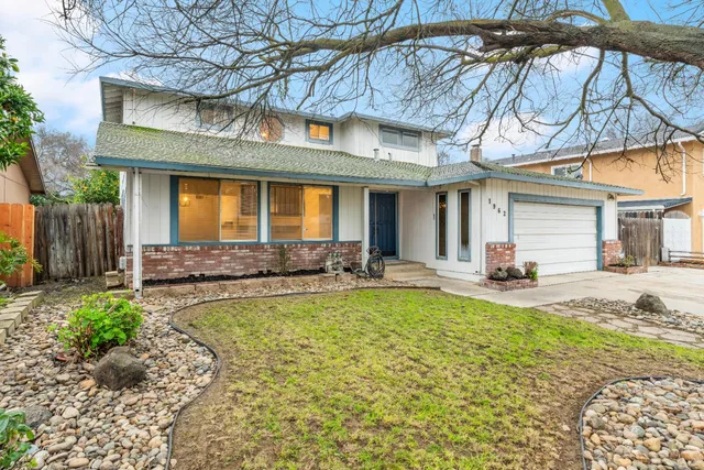 a view of a house with swimming pool and sitting area