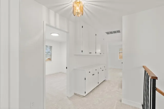 a spacious bathroom with a shower a sink and mirror