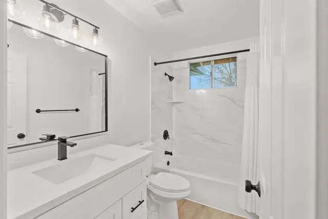 an aerial view of a house with a garden and trees