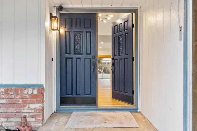 a view of an entryway with wooden floor