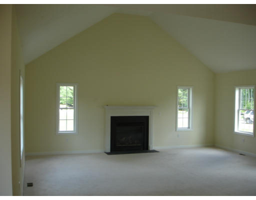 Lot 1 Harbor Trace Road Townsend, MA 01469 - Photo 4 of 6 a living room with a fireplace and windows