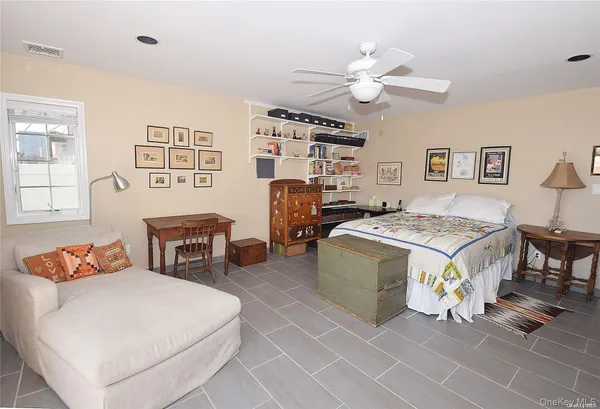 a living room with a bed and a window