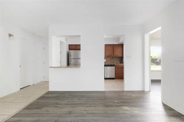 a view of a kitchen with wooden cabinet and a refrigerator
