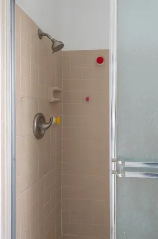 a bathroom with a shower and a sink