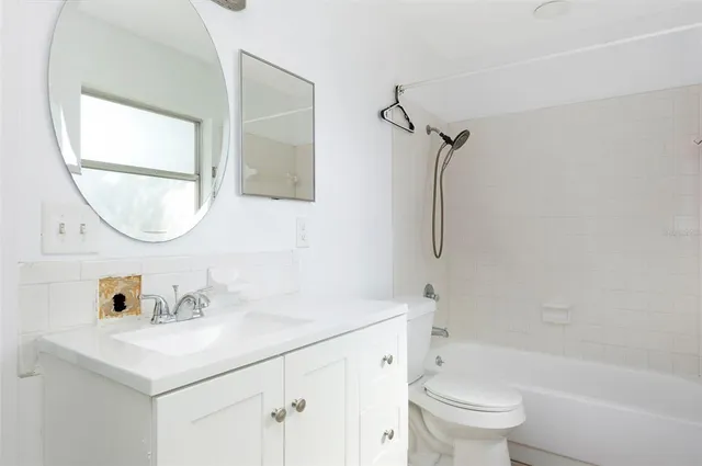 a bathroom with a sink toilet and a mirror