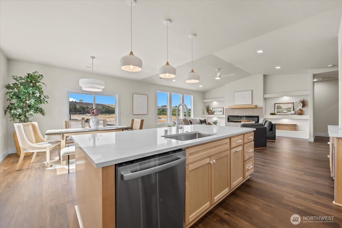 1040 South Florida Place Kennewick, WA 99338 - Photo 15 of 33 a kitchen with stainless steel appliances kitchen island granite countertop a table chairs and a refrigerator