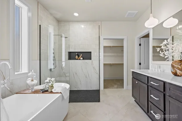 a bathroom with a bathtub and a shower