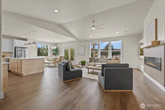 a living room with fireplace furniture and a wooden floor