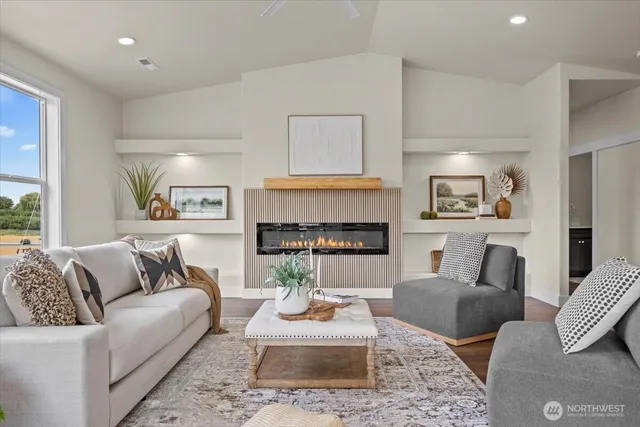 a living room with furniture and a fireplace
