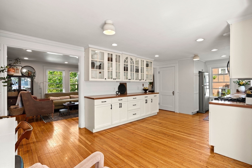34 Avalon Road Milton, MA 02186 - Photo 17 of 42 a kitchen with stainless steel appliances granite countertop a stove a sink a refrigerator and a dining table with wooden floor