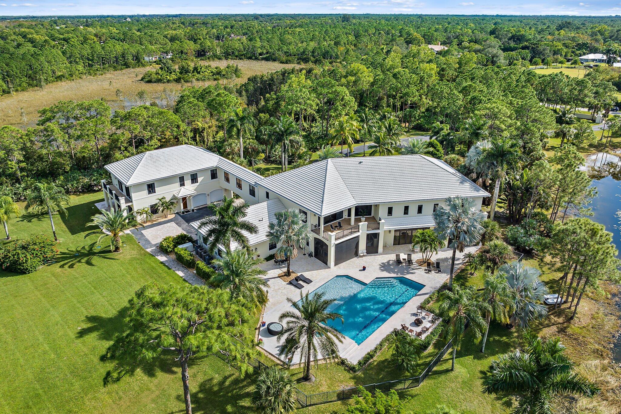 an aerial view of a house with garden space and outdoor seating