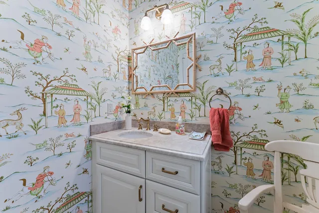 a living room with furniture kitchen view and a large window
