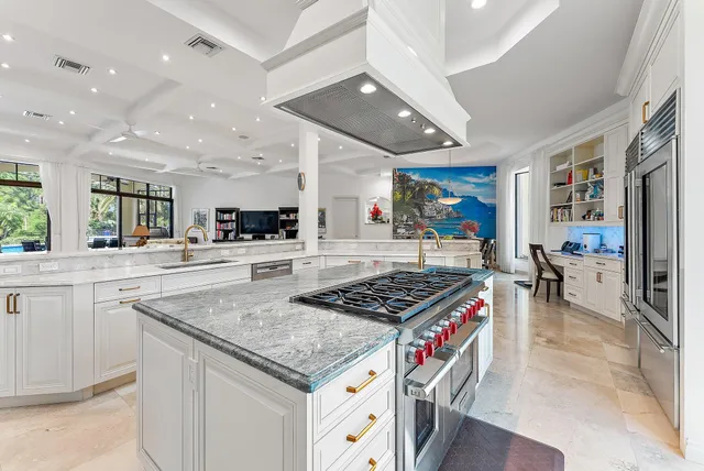 a dining room with furniture a potted plant and a floor to ceiling window