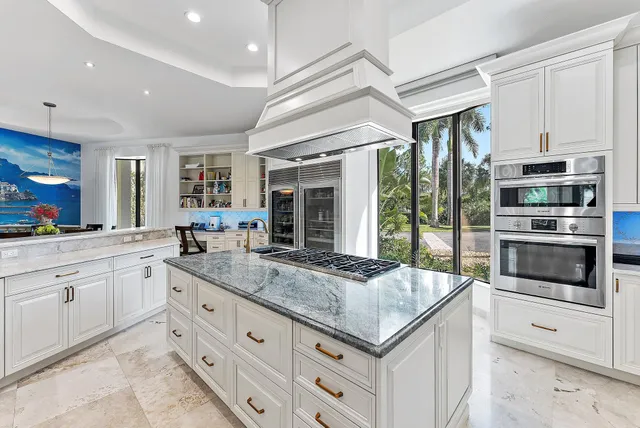 a living room with patio furniture and a floor to ceiling window