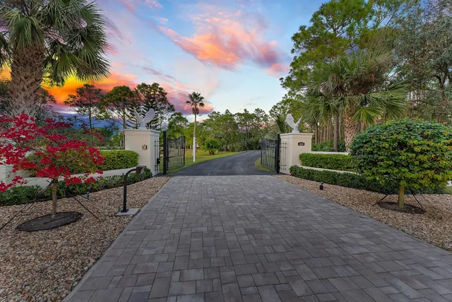 a view of a street with a flower garden in front of it