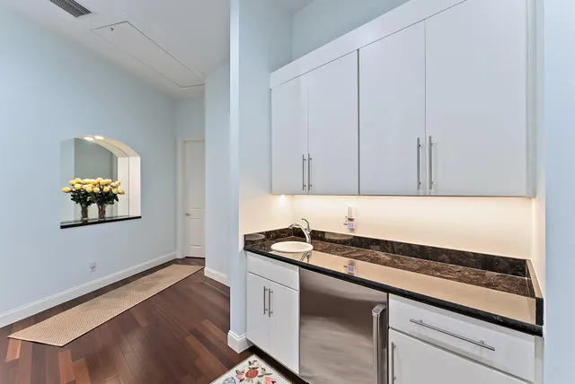 a kitchen with a sink and chairs