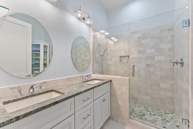 a view of swimming pool with lounge chair and palm trees