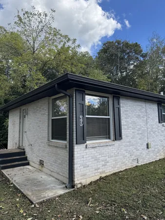 a front view of a house with trees