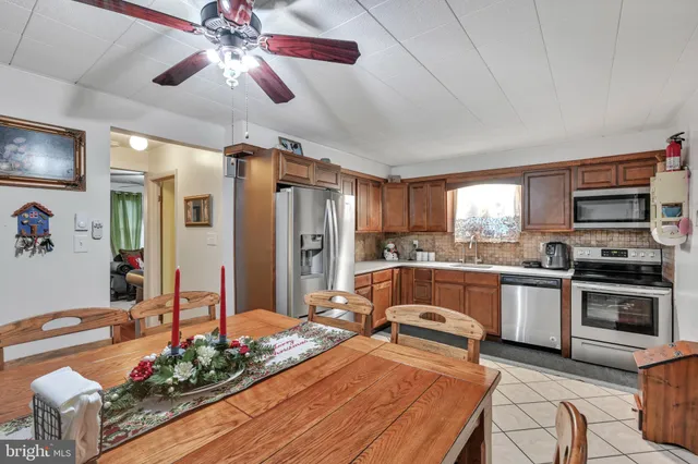 a kitchen with stainless steel appliances kitchen island granite countertop a stove and a sink