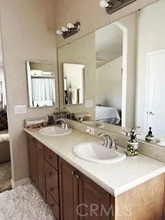 24922 Muirlands Lake, Unit 115 Lake Forest, CA 92630 - Photo 12 of 17 a bathroom with a sink and a mirror