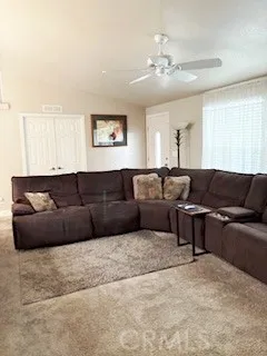 24922 Muirlands Lake, Unit 115 Lake Forest, CA 92630 - Photo 14 of 17 a living room with a couch and chandelier