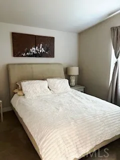24922 Muirlands Lake, Unit 115 Lake Forest, CA 92630 - Photo 10 of 17 a large white bed in a small room