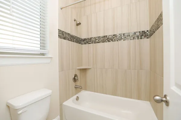 a bathroom with a shower curtain and a toilet