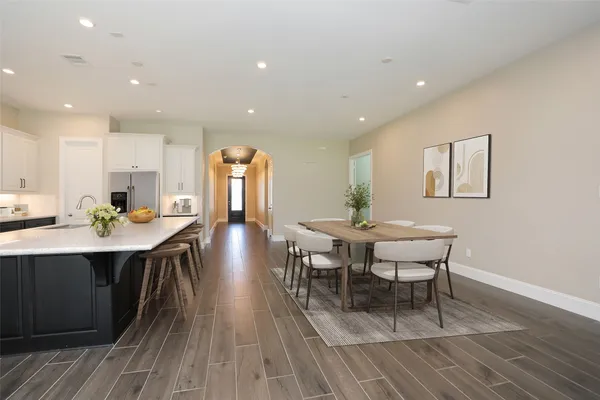 a view of a dining room with furniture and wooden floor