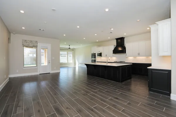 a kitchen with stainless steel appliances kitchen island wooden cabinets and granite counter tops